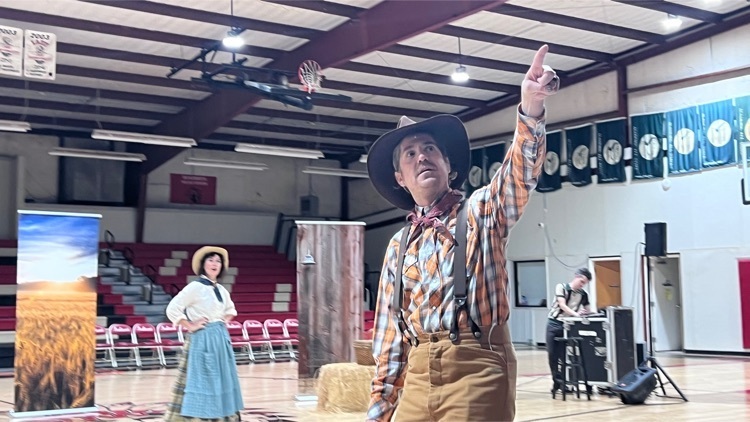 a group of actor performing Oklahoma